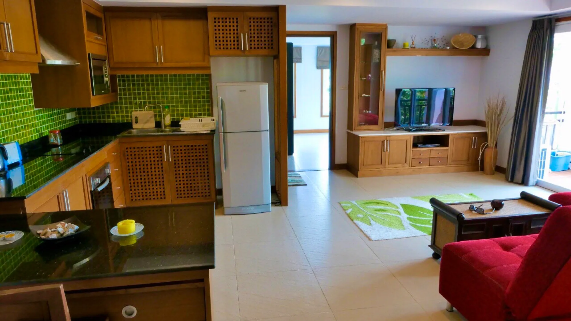 Open kitchen and living area with the balcony door beyond