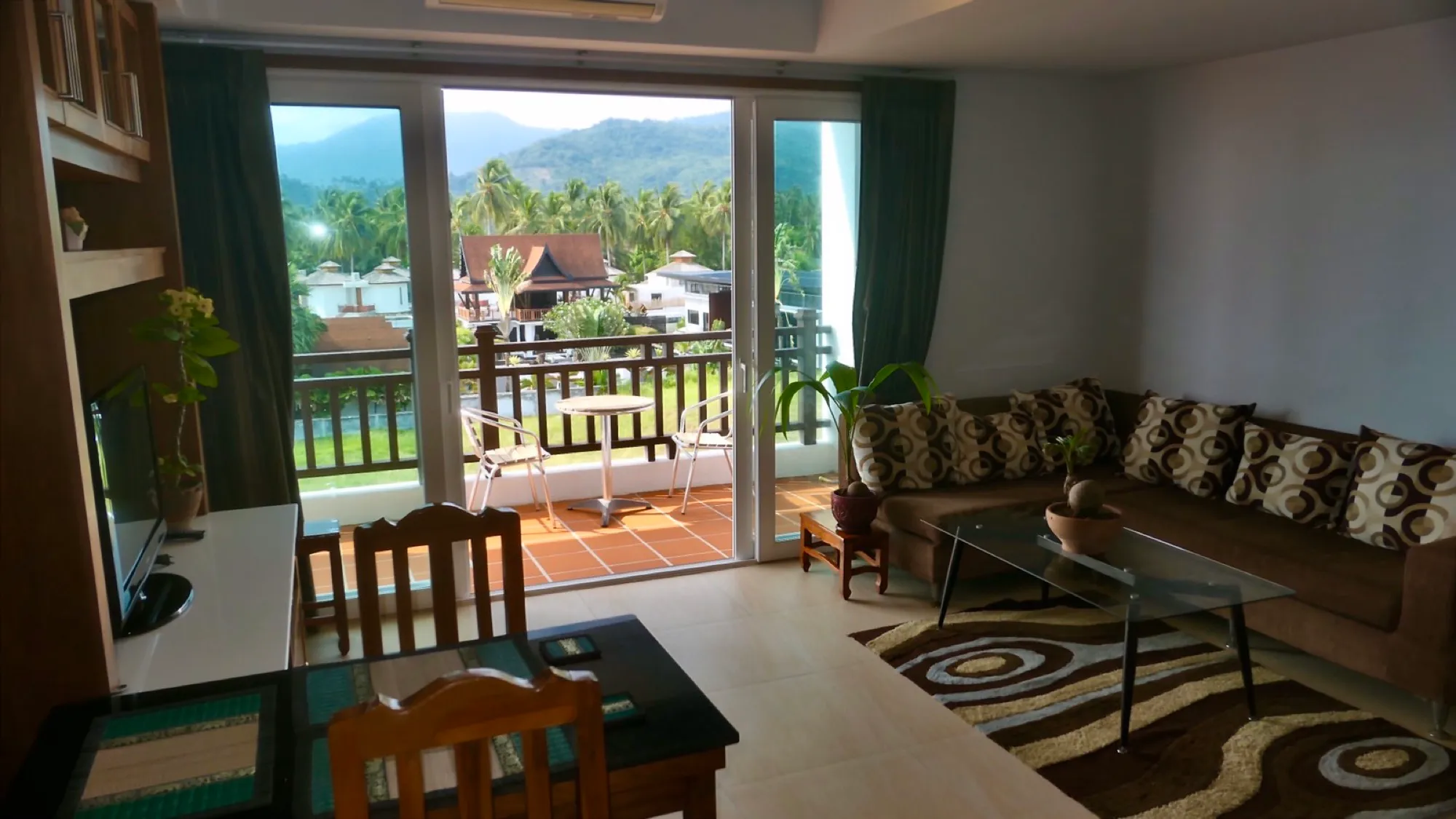 Long balcony with a table and two chairs